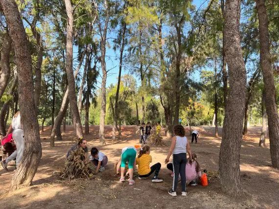 kids creating a tent with branches