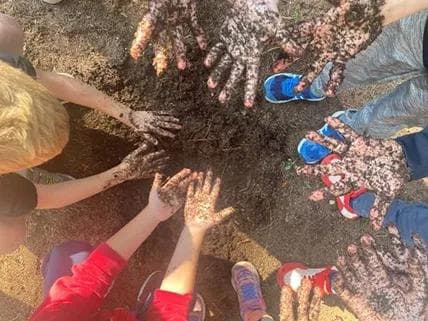 Children making objects out of natural materials found in the park.