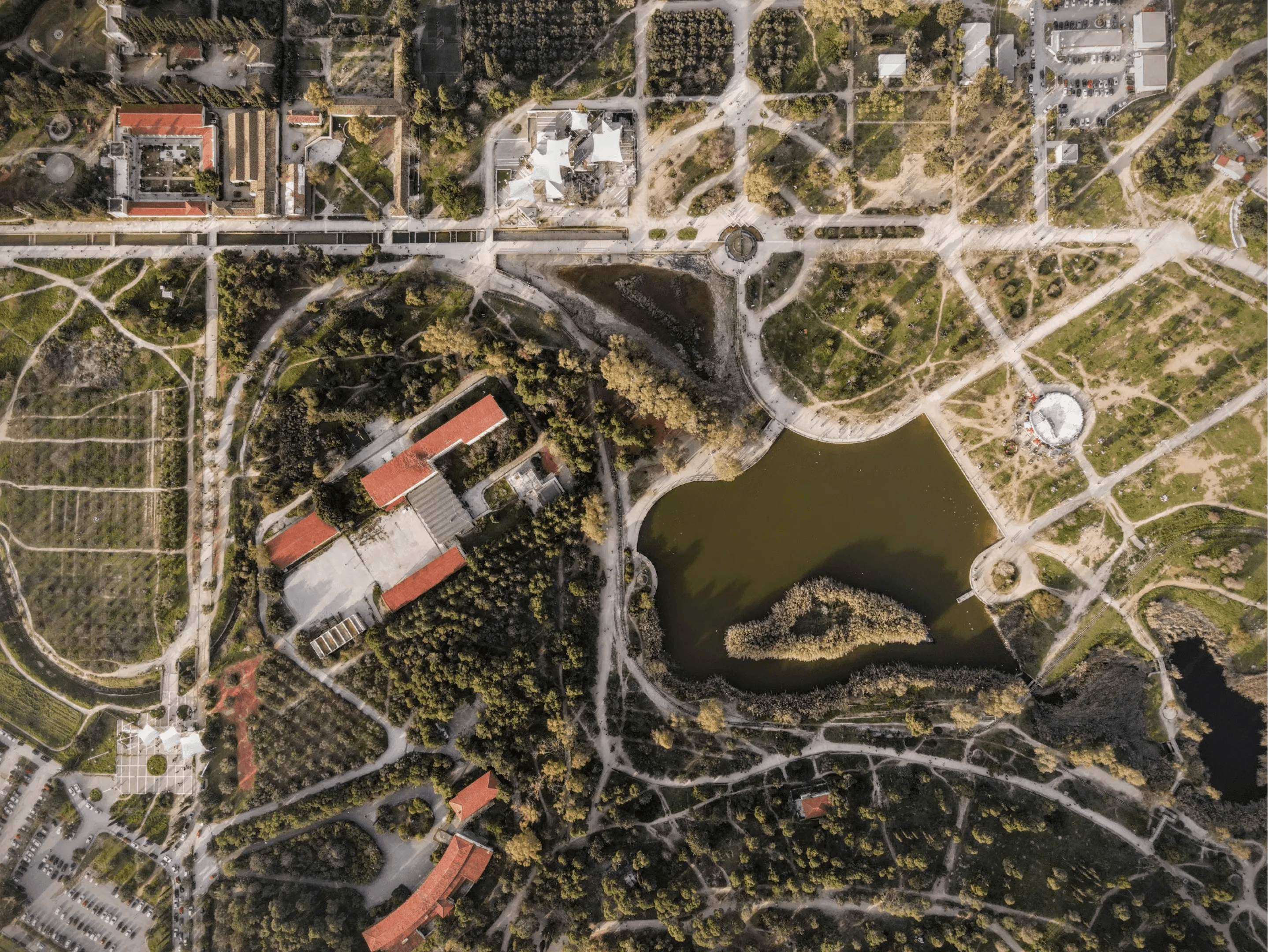 A satellite view of a region with houses and roads.